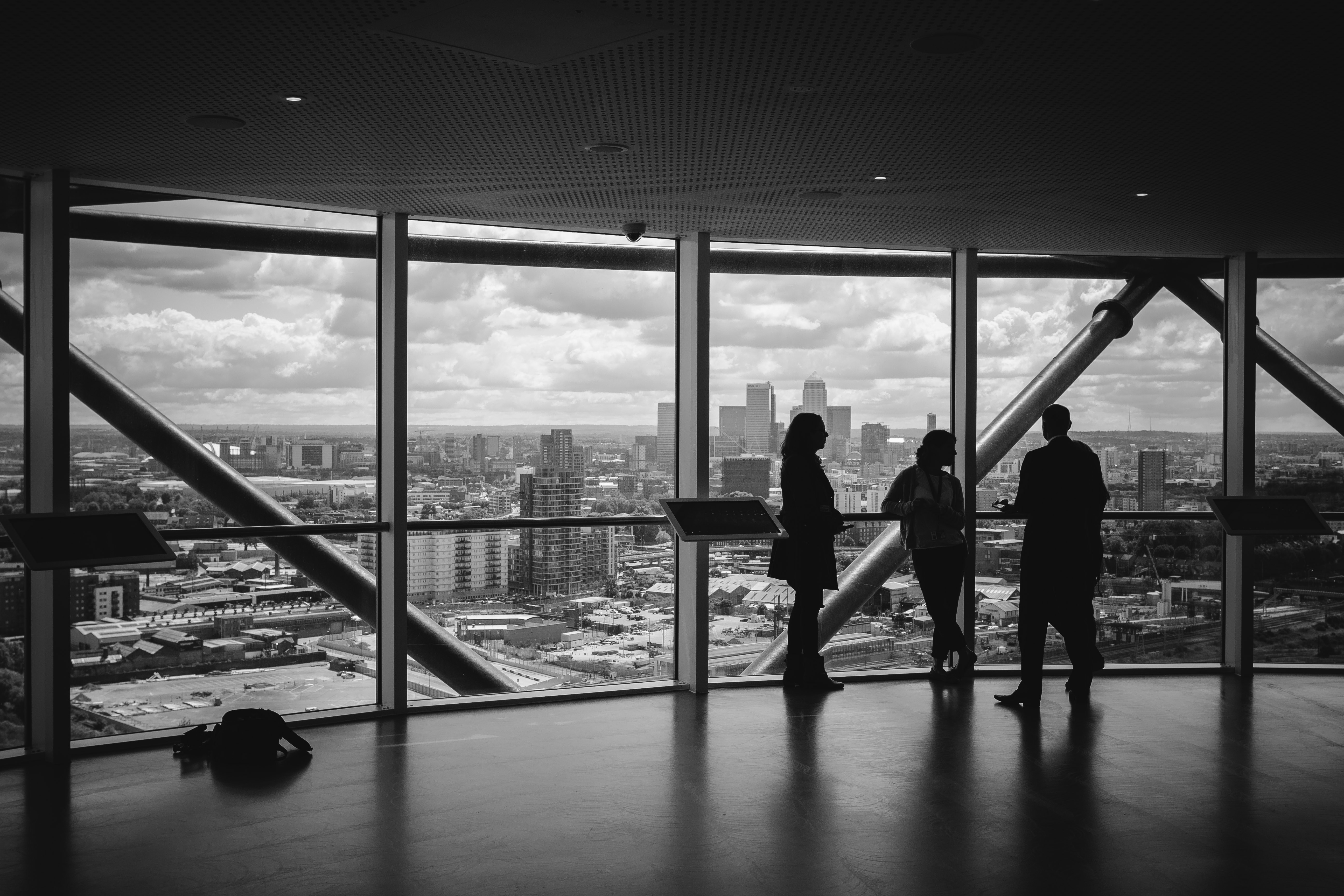 Business professionals discussing strategy overlooking a city skyline